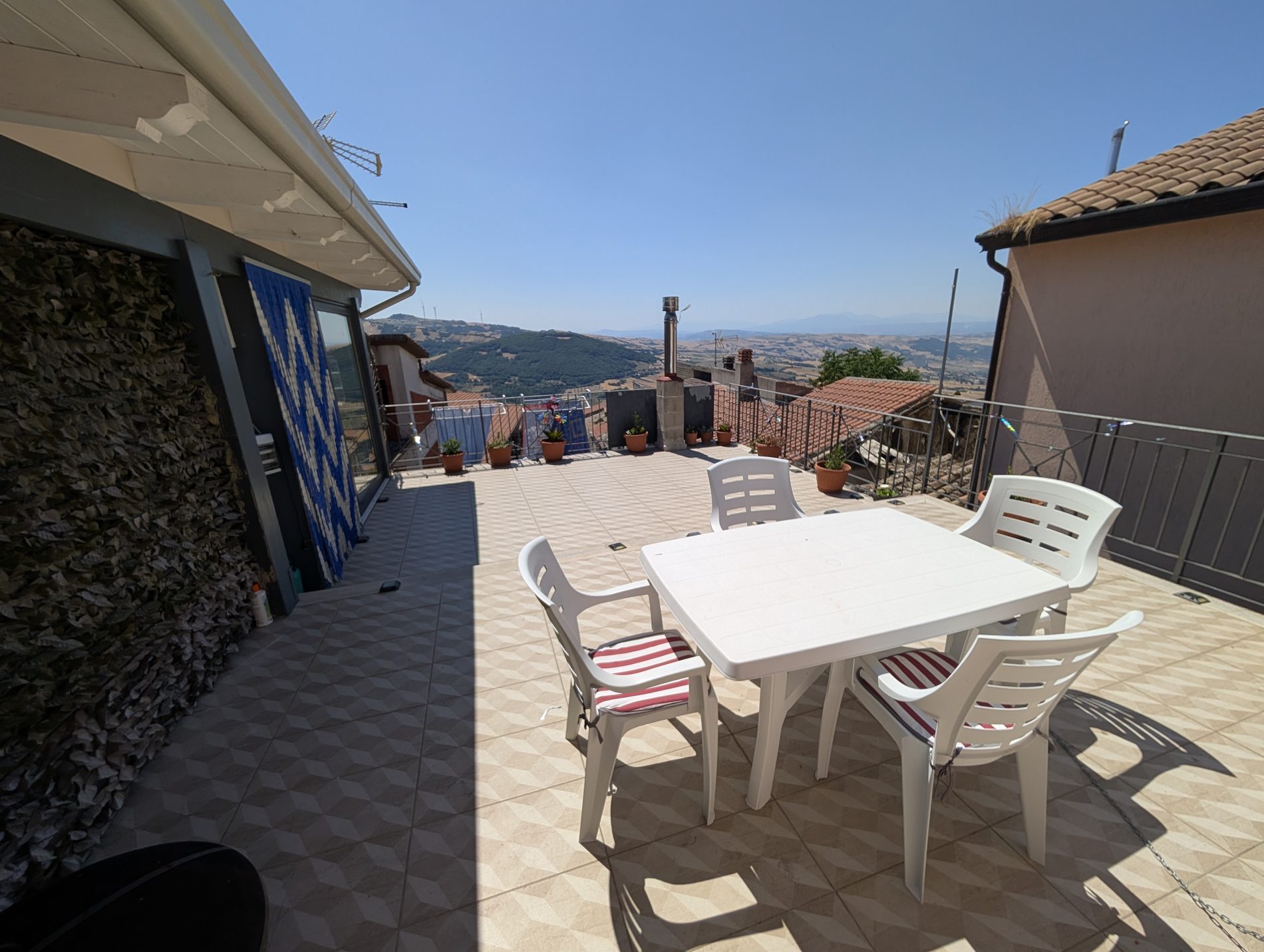 Roof terrace with table and valley view
